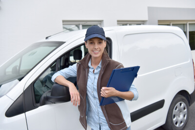 delivery woman standing by van